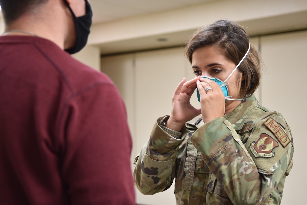 A woman is fitted for a mask.