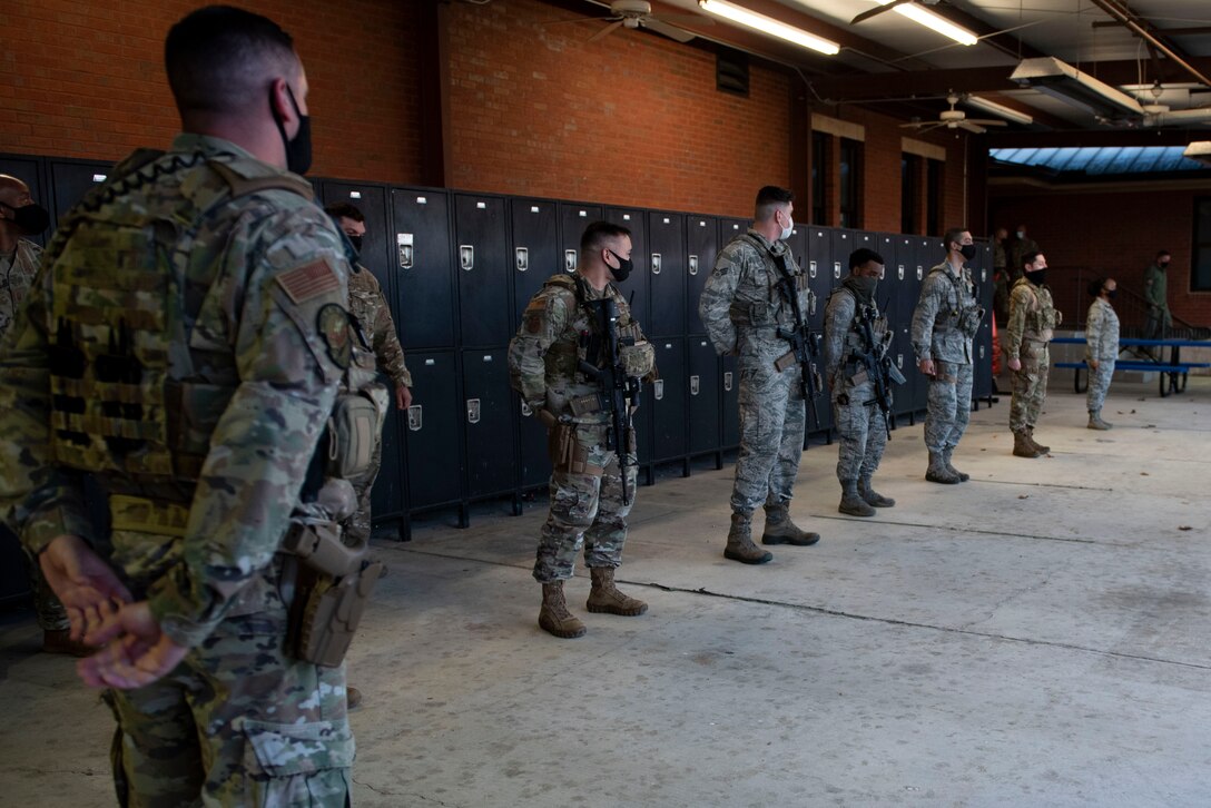 A photo of Airmen listening to leadership during a visit.