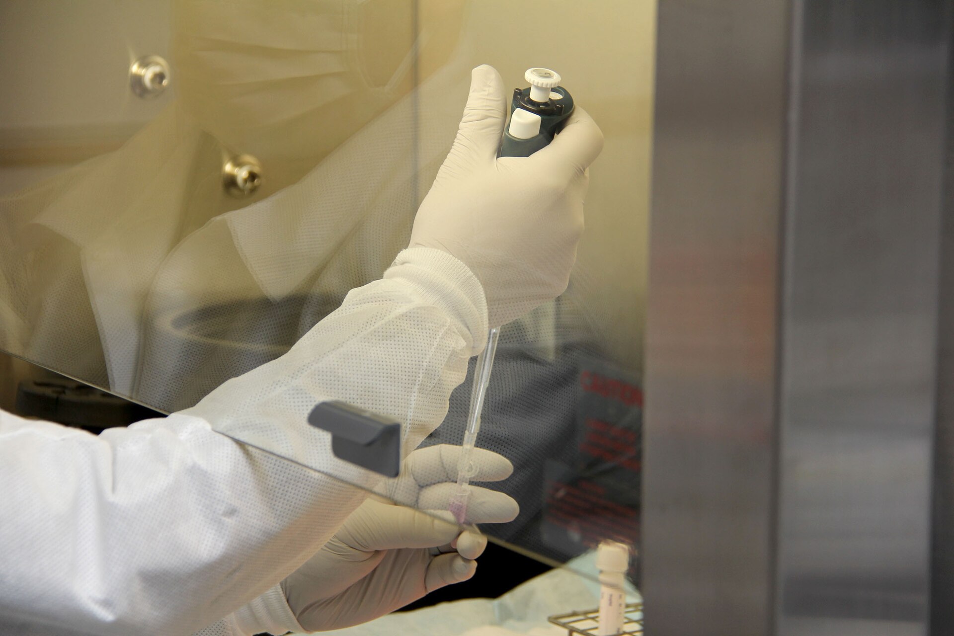 Spc. Darius Torres, of Littlefield, Texas, a medical laboratory technician assigned to Public Health Activity-Fort Lewis, polls and extracts ribonucleic acid, or RNA, while demonstrating the command’s new COVID-19 pooled testing procedures to Brig. Gen. Jack M. Davis, commanding general of Regional Health Command-Pacific, at PHC-P’s new COVID-19 Surveillance Testing Laboratory, Dec. 3, 2020. (U.S. Army photo by Christopher Larsen, RHC-P Public Affairs)