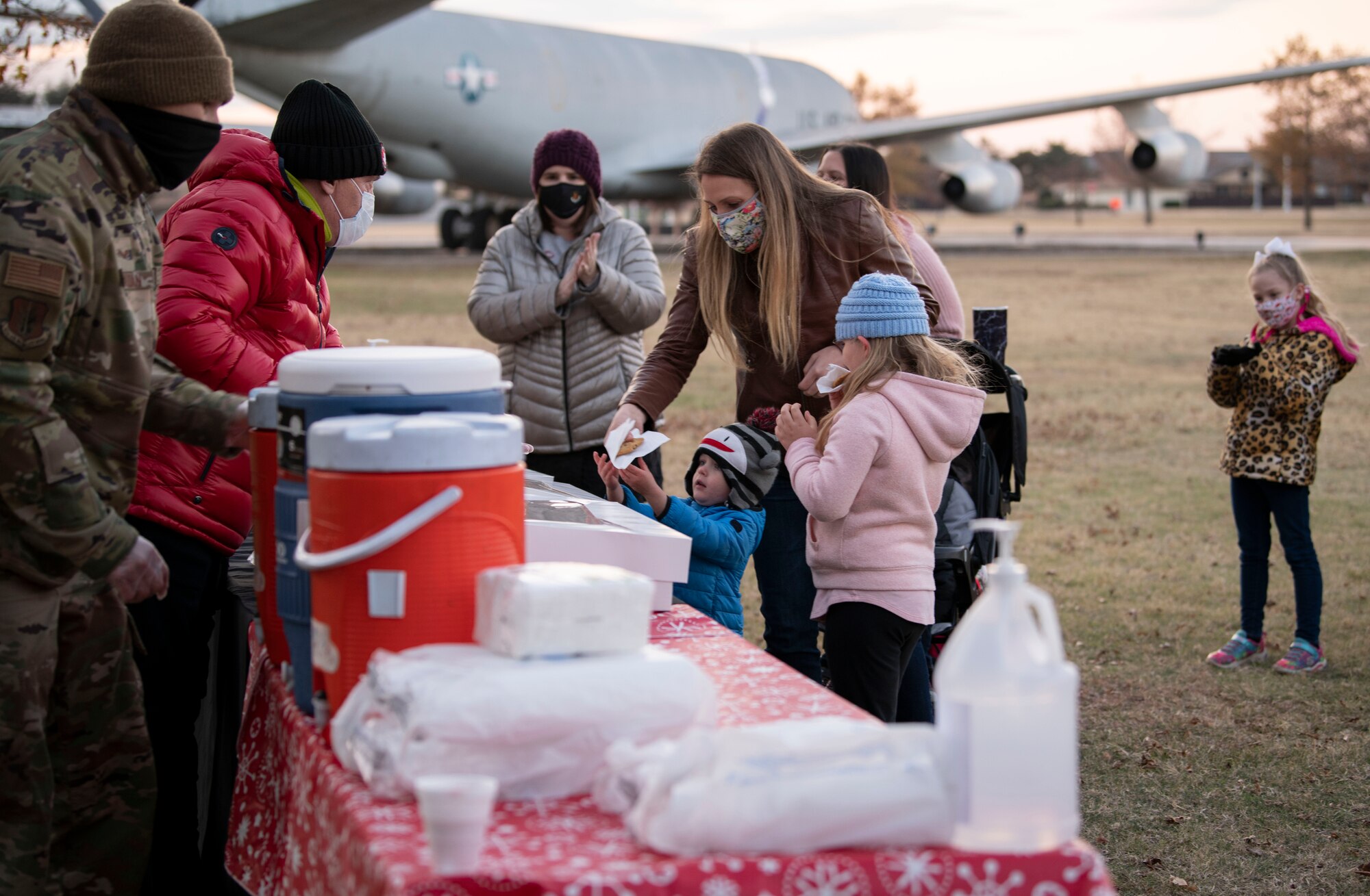 Families receive cookies and refreshments during the annual holiday tree lighting event, Dec. 3, 2020, at Altus Air Force Base, Oklahoma. The cookies and refreshments were provided by the base chapel and handed out by volunteers. (U.S. Air Force photo by Airman 1st Class Amanda Lovelace)