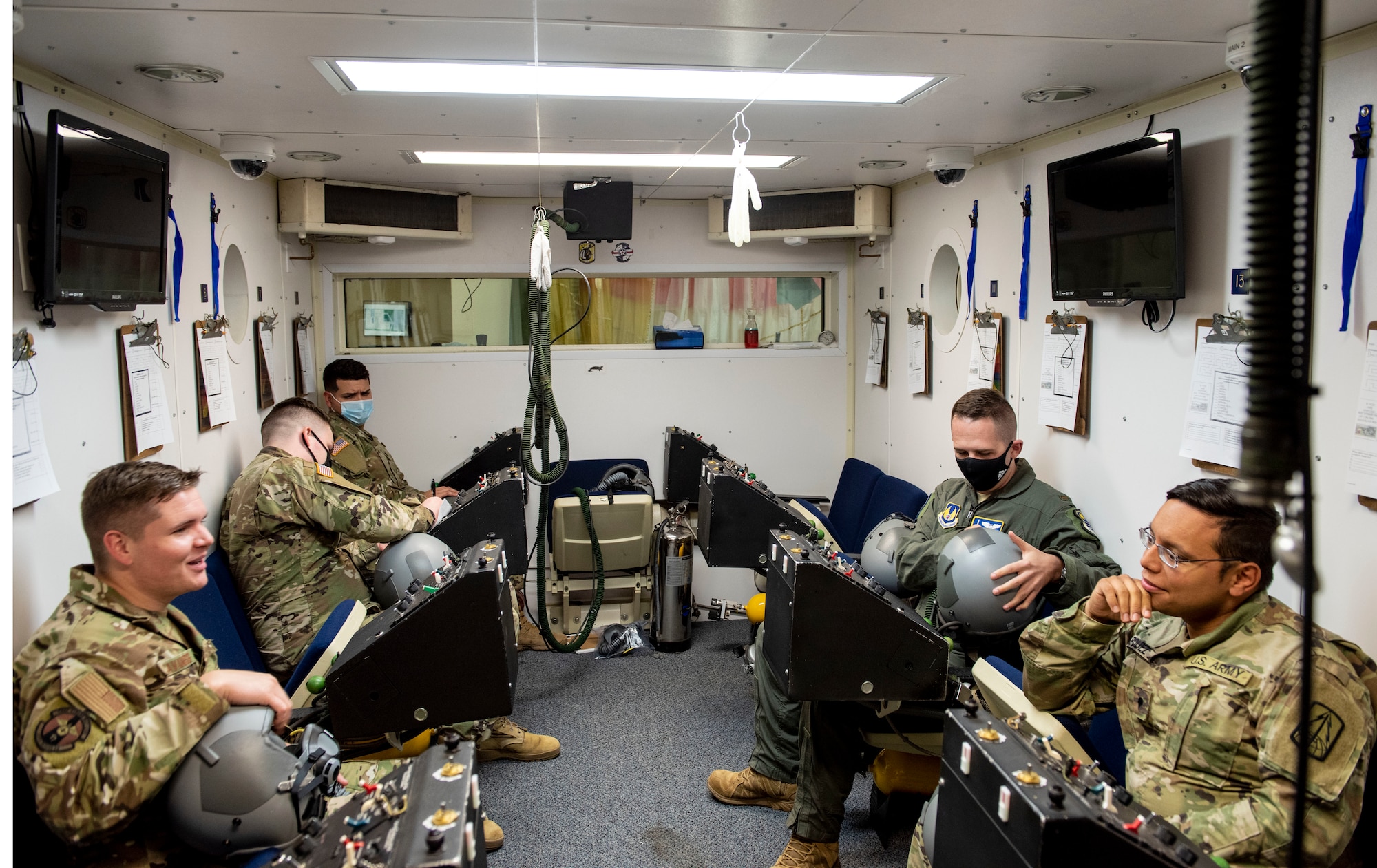 Service members prepare and set up their equipment before going through the altitude chamber to test their hypoxia symptoms on Nov. 23, 2020, Laughlin Air Force Base, Texas. It's important to know one’s own symptoms of hypoxia so you can take  measures to correct it. (U.S. Air Force photo by Airman 1st Class David Phaff)