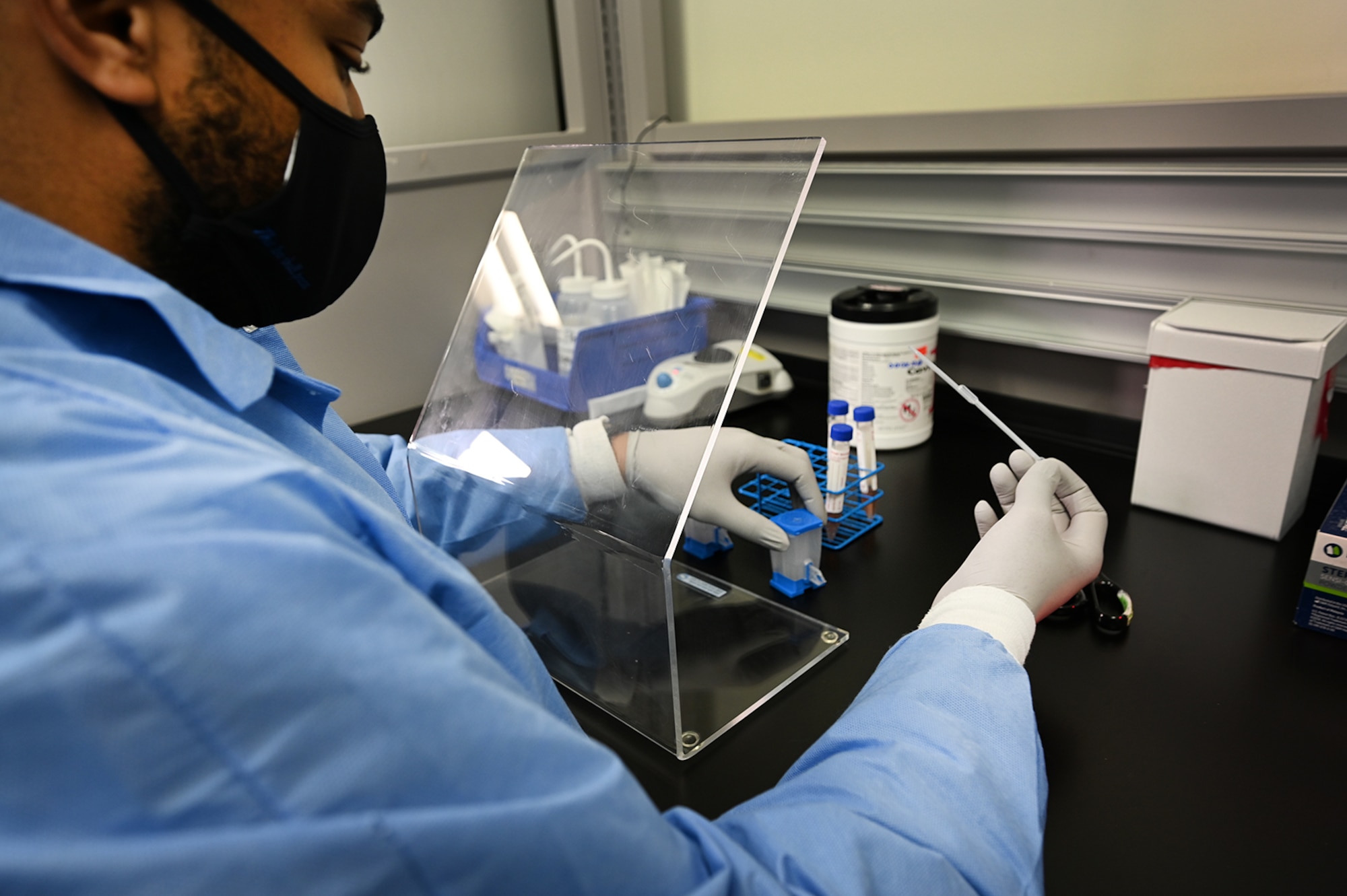 Senior Airman Ezekiel Grogan, 66th Medical Squadron Laboratory technician, tests a lab sample at Hanscom Air Force Base, Mass., Dec. 3. Grogan is one of five Hanscom technicians responsible for collecting all routine lab work as well as COVID tests taken on the installation. (U.S. Air Force photo by Todd Maki)