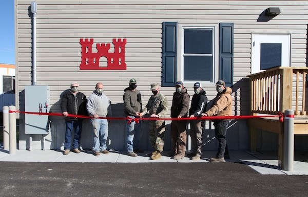 Col. Bill Hannan together with the team who works at Gasconade River Office to cut the ribbon Dec. 1, 2020: left to right, Randall Faherty, Brandon Willis, Kenneth Schneider, Col. Hannan, Nick Slocum, Michael McMillian and Kevin Tune - cutting the ribbon symbolically opening the new building designed and built by Vazquez Commercial Contracting, headquartered in Kansas City, Mo. Photo by Jennie Wilson, Visual Information Specialist, Kansas City District, USACE.