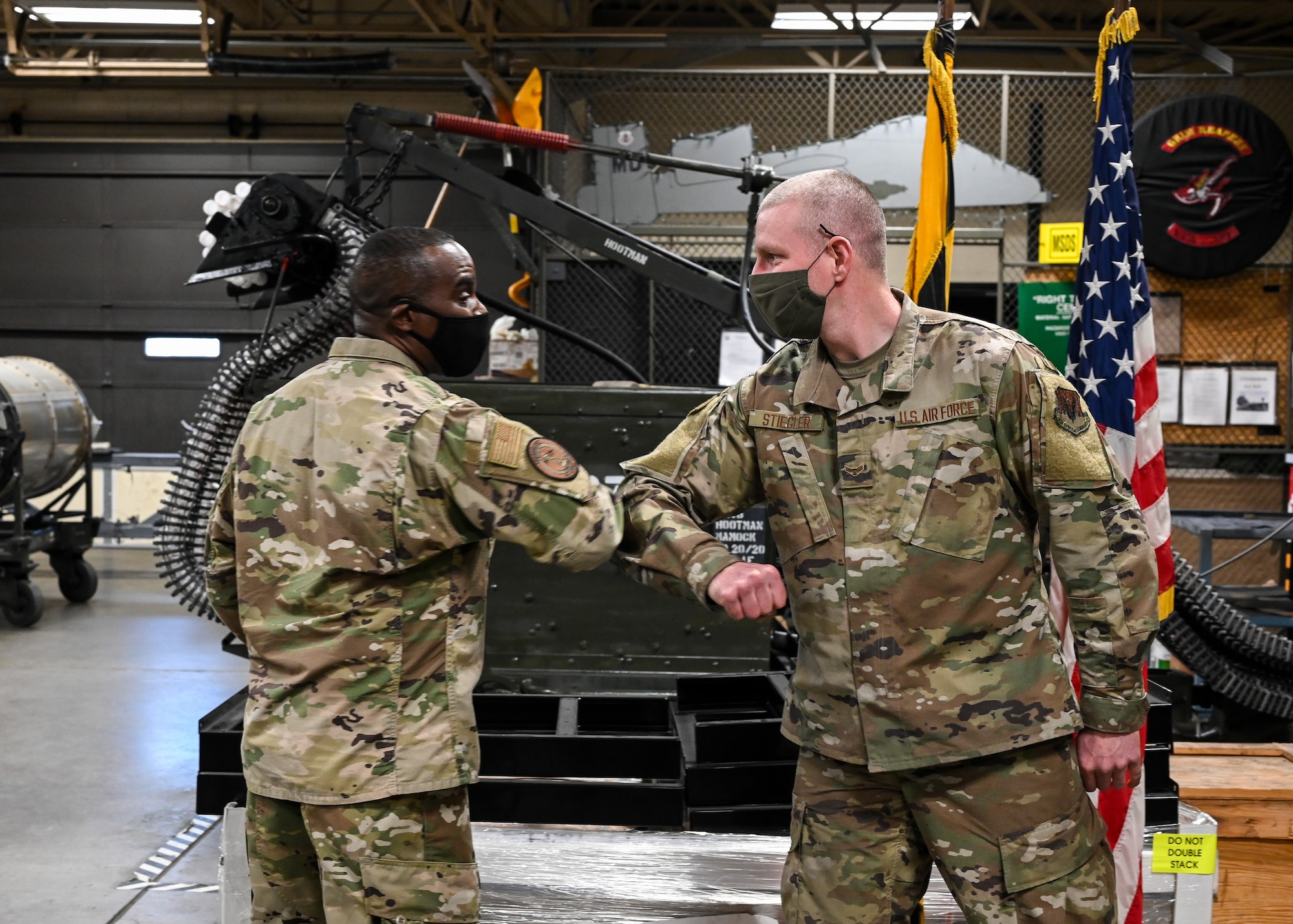 Chief Master Sgt. Maurice L. Williams, command chief master sergeant of the Air National Guard, elbow bumps Airman 1st Class Werner Stiegler, weapons specialist for the 175th Aircraft Maintenance Squadron, at Warfield ANG Base at Martin State Airport, Middle River, Md, Nov. 7, 2020. Williams recognized Stiegler for his outstanding service and dedication to the Maryland Air National Guard. (U.S. Air National Guard photo by Staff Sgt. Sarah M. McClanahan)