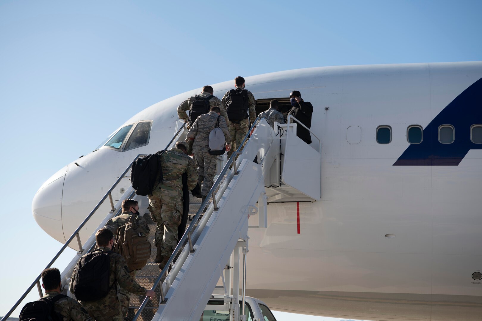 Airmen assigned to the 37th Expeditionary Bomb Squadron, board a flight prior to a Bomber Task Force deployment from Ellsworth Air Force Base, S.D., Nov. 28, 2020. Bomber Task Force missions allow the U.S. to showcase its commitment to allies and partners anytime. (U.S. Air Force photo by Airman Jonah Fronk)