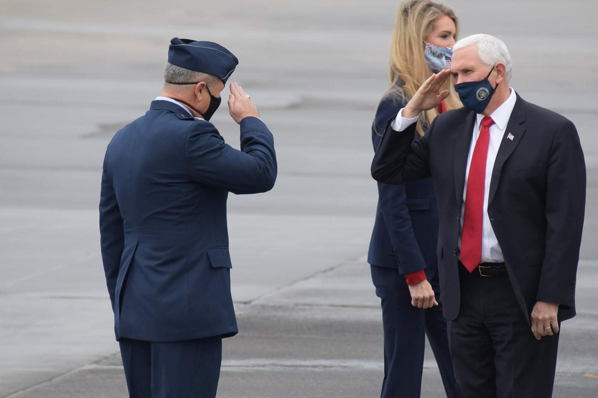 Vice President Mike Pence returns a salute to Col. Craig McPike, 94th Airlift Wing commander, while transiting through Dobbins Air Reserve Base, Friday, Dec 4, 2020.