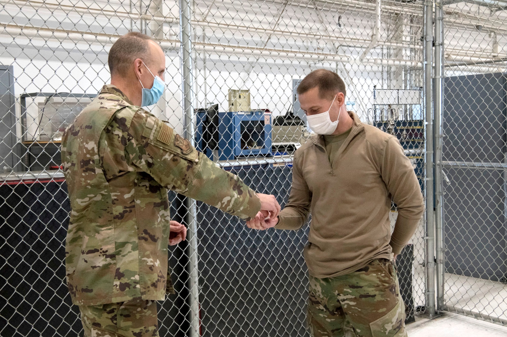 Col. Christopher Zidek, 302nd Airlift Wing commander, coins Tech. Sgt. David Novak, 302nd Maintenance Squadron Aerospace Ground Equipment technician, during the December unit training assembly, Dec. 5, 2020, at Peterson-Schriever Garrison, Colorado.