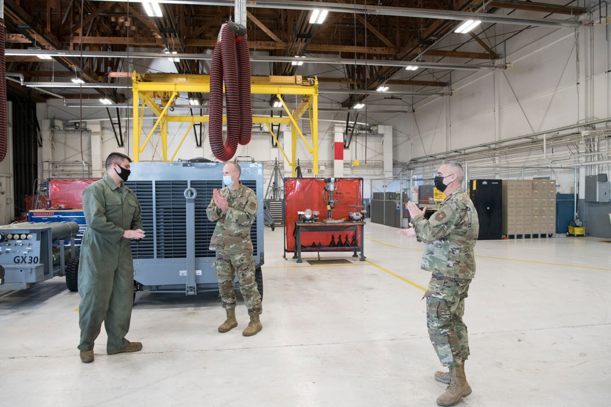 Staff Sgt. John Stevenson (left), 302nd Maintenance Squadron Aerospace Ground Equipment technician, receives a coin for outstanding performance from during the December unit training assembly, Dec. 5, 2020, at Peterson-Schriever Garrison, Colorado.