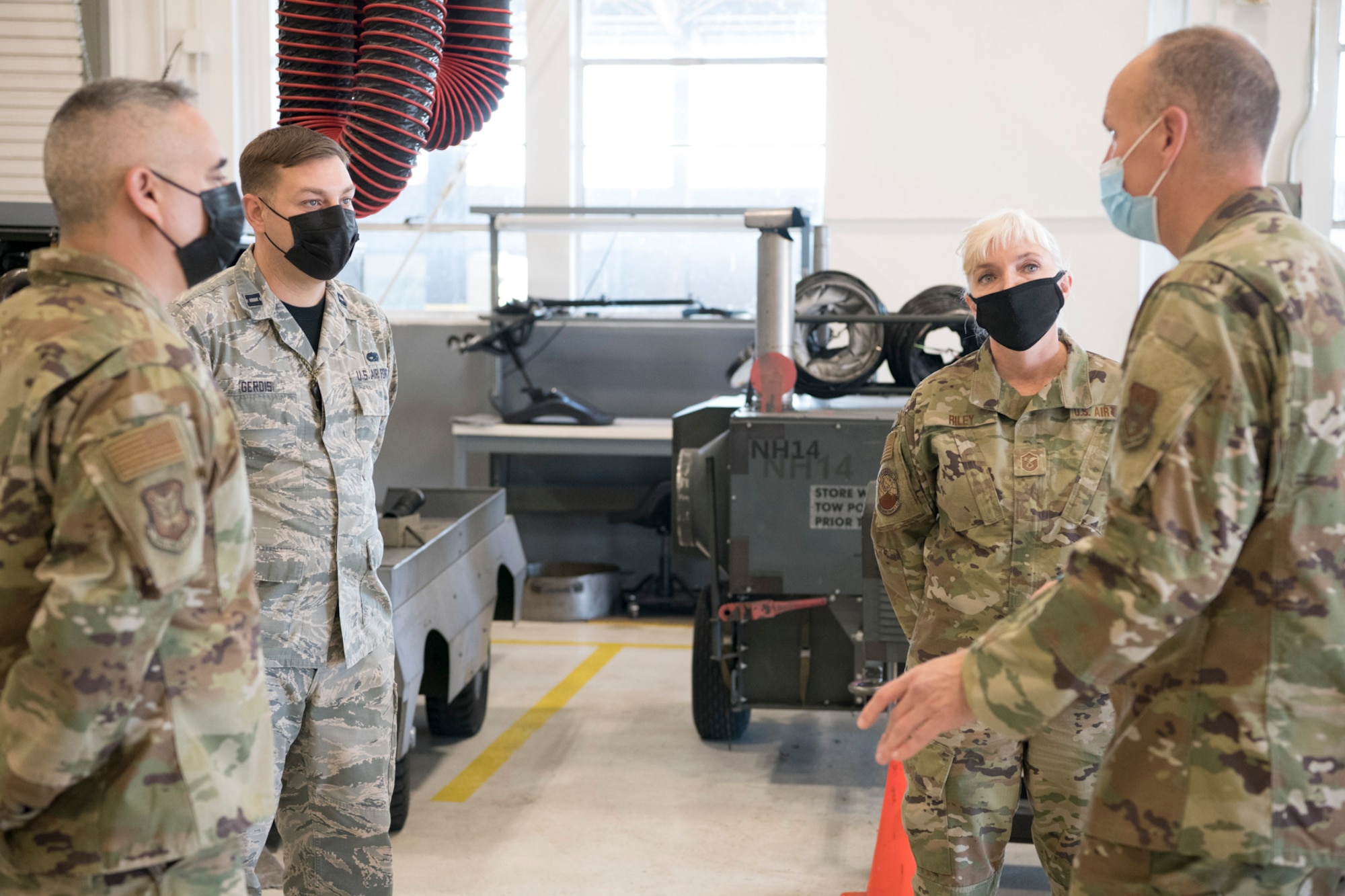 Col. Christopher Zidek (right), 302nd Airlift Wing commander, and Chief Master Sgt. Kahn Scalise (left), 302 AW command chief, meet with Capt. James Gerdis, 302nd Maintenance Squadron operations officer and Master Sgt. Sandy Riley, 302 MXS Aerospace Ground Equipment flight chief, during a squadron visit, Dec. 5, 2020, at Peterson-Schriever Garrison, Colorado.