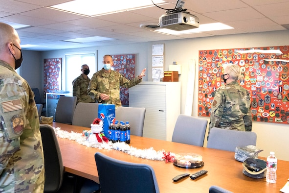 Col. Christopher Zidek (right), 302nd Airlift Wing commander, and Chief Master Sgt. Kahn Scalise (left), 302 AW command chief, meet with Capt. James Gerdis, 302nd Maintenance Squadron operations officer and Master Sgt. Sandy Riley, 302 MXS Aerospace Ground Equipment flight chief, during a squadron visit, Dec. 5, 2020, at Peterson-Schriever Garrison, Colorado.