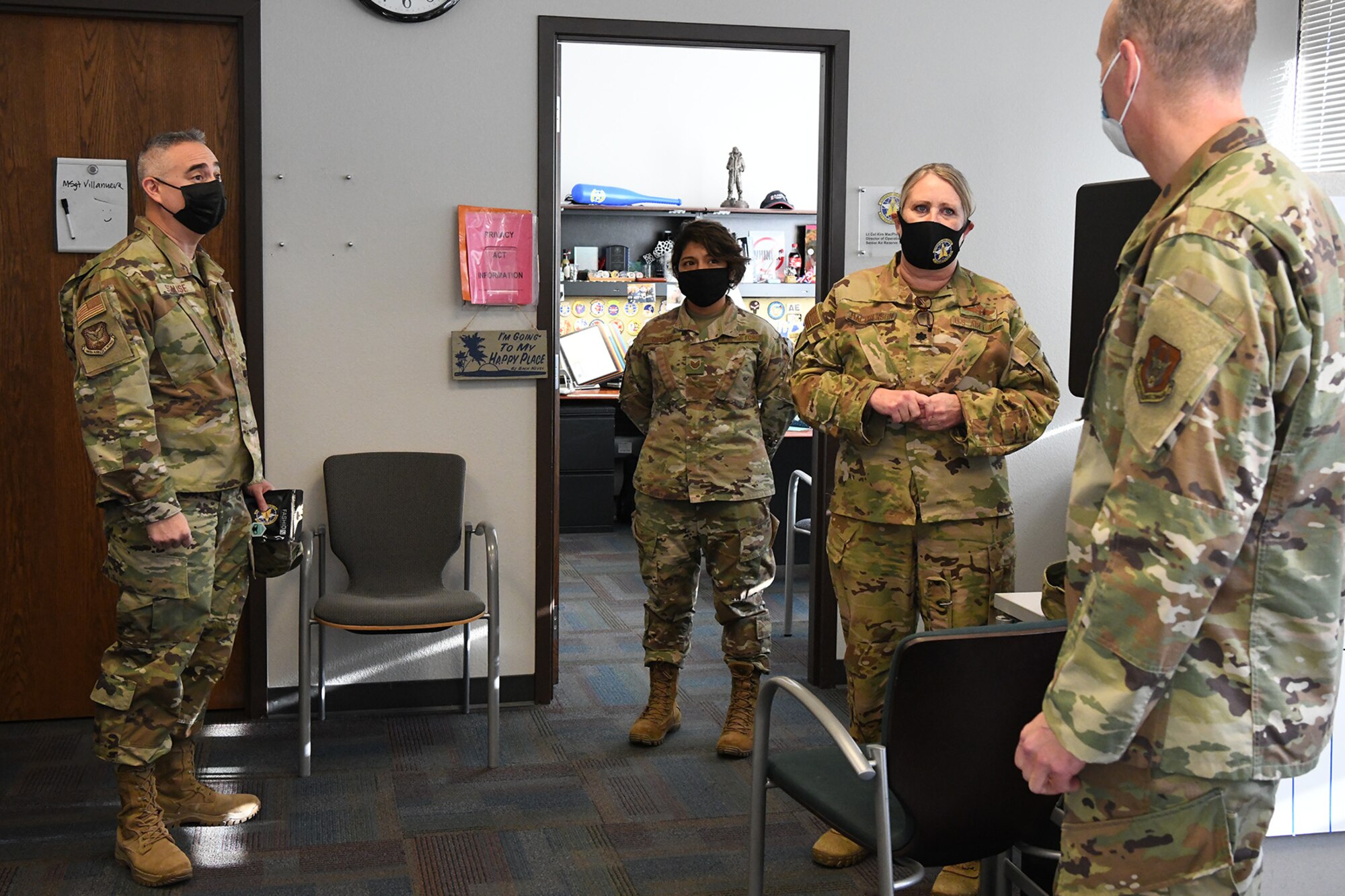 Col. Christopher Zidek (right), 302nd Airlift Wing commander, and Chief Master Sgt. Kahn Scalise (left), 302 AW command chief, visit with reservists with the 34th Aeromedical Evacuation Squadron during the December unit training assembly, Dec. 6, 2020, at Peterson-Schriever Garrison, Colorado.