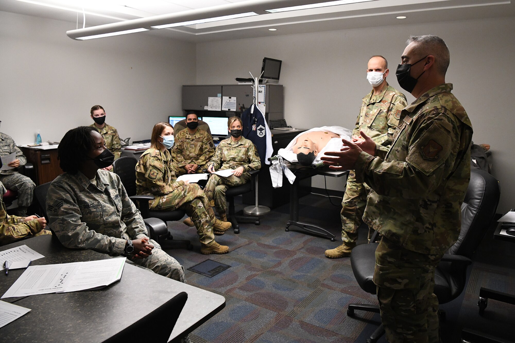 Chief Master Sgt. Kahn Scalise (right), 302nd Airlift Wing command chief, speaks with reservists with the 34th Aeromedical Evacuation Squadron during the December unit training assembly, Dec. 6, 2020, at Peterson-Schriever Garrison, Colorado.