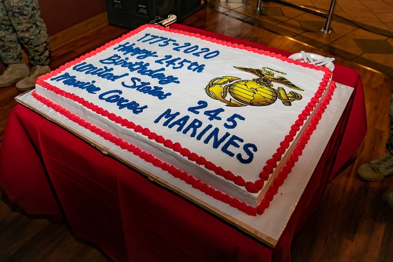 U.S. Marines with 3rd Marine Expeditionary Brigade celebrate the 245th Marine Corps birthday with a cake cutting ceremony at the Bayview Club, Camp Courtney, Okinawa, Japan, Nov. 13, 2020. Marines throughout the world celebrate the Marine Corps birthday in November. During the ceremony, a piece of cake is passed from the oldest Marine to the youngest Marine, which signifies the passing of knowledge and wisdom from one generation to the next. (U.S. Marine Corps photo by Lance Cpl. Natalie Greenwood)