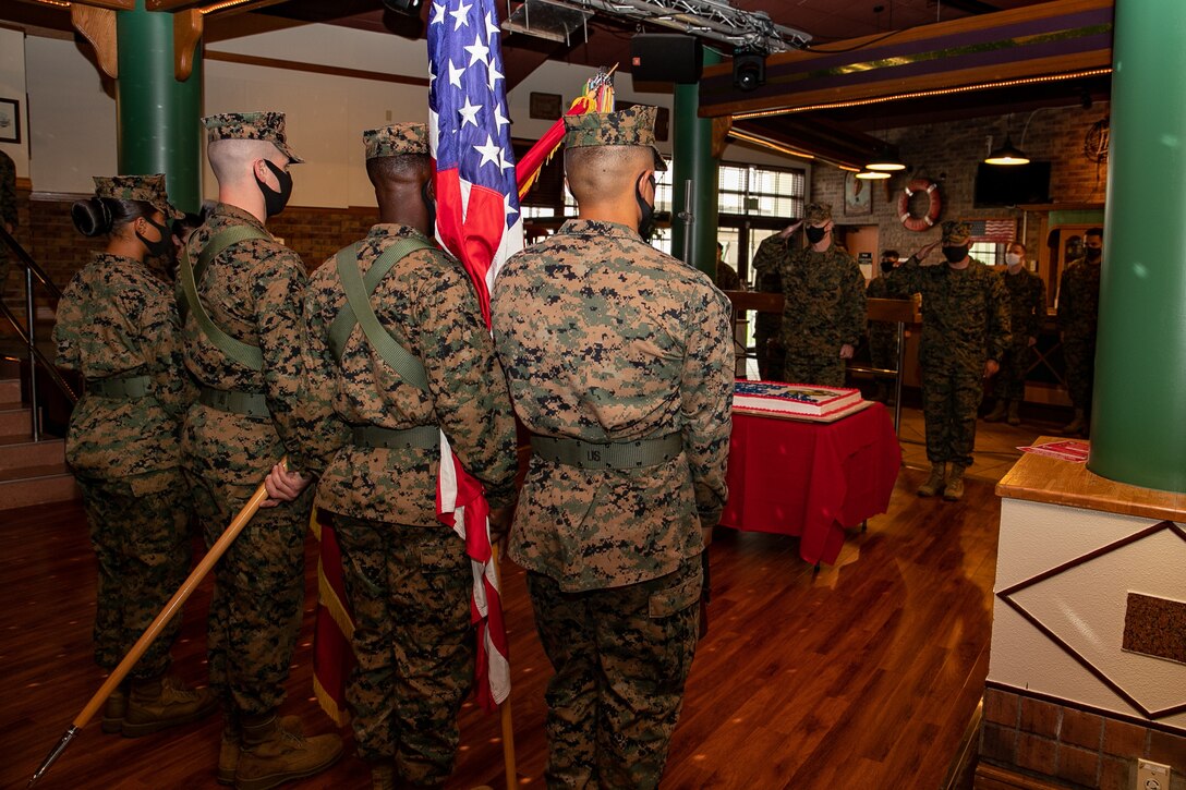 U.S. Marines with 3rd Marine Expeditionary Brigade celebrate the 245th Marine Corps birthday with a cake cutting ceremony at the Bayview Club, Camp Courtney, Okinawa, Japan, Nov. 13, 2020. Marines throughout the world celebrate the Marine Corps birthday in November. During the ceremony, a piece of cake is passed from the oldest Marine to the youngest Marine, which signifies the passing of knowledge and wisdom from one generation to the next. (U.S. Marine Corps photo by Lance Cpl. Natalie Greenwood)