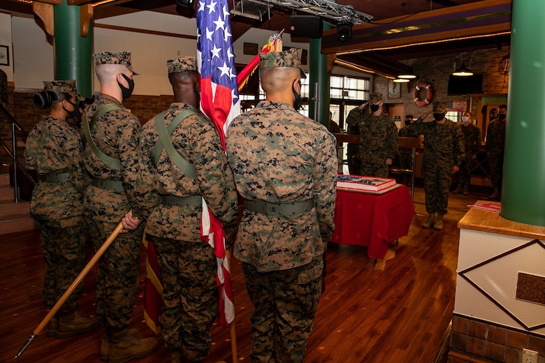U.S. Marines with 3rd Marine Expeditionary Brigade celebrate the 245th Marine Corps birthday with a cake cutting ceremony at the Bayview Club, Camp Courtney, Okinawa, Japan, Nov. 13, 2020. Marines throughout the world celebrate the Marine Corps birthday in November. During the ceremony, a piece of cake is passed from the oldest Marine to the youngest Marine, which signifies the passing of knowledge and wisdom from one generation to the next. (U.S. Marine Corps photo by Lance Cpl. Natalie Greenwood)
