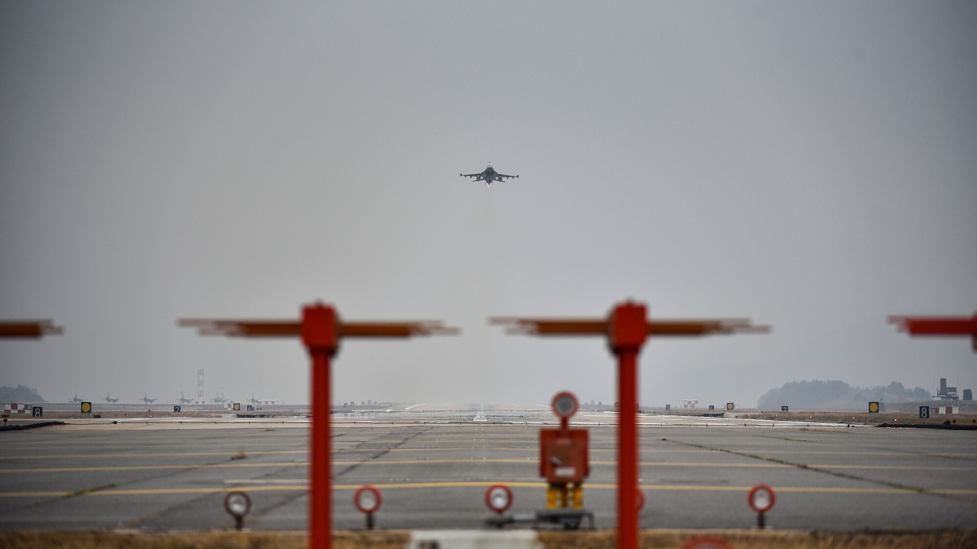 A jet taking off from the flight line.
