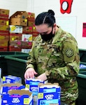 A Soldier serving with Task Force Spartan, the Michigan National Guard’s COVID-19 response team assigned to Michigan food banks, repacks Pop-Tarts at Feeding America West Michigan, Comstock Park, Michigan, Nov. 17, 2020.