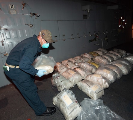 A Sailor assigned to the guided-missile destroyer USS Ralph Johnson (DDG 114) arranges narcotics seized during a visit, board, search, and seizure operation in support of Combined Maritime Forces (CMF) Combined Task Force (CTF) 150 in the Arabian Sea, Dec. 4.