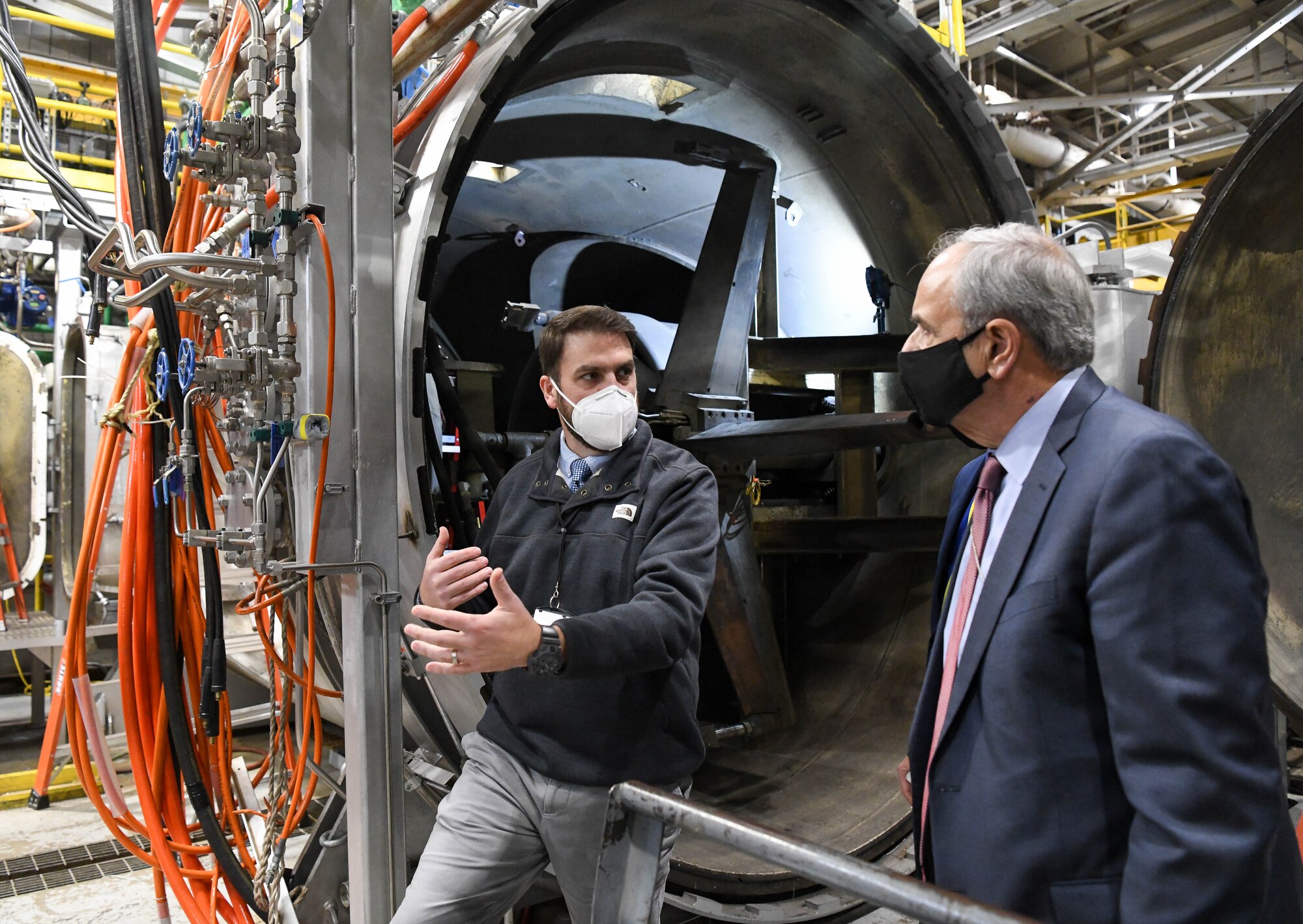 Benjamin Holton, left, section chief of the High-Temperature Materials Characterization and Evaluation capability within the Space and Missile Test Branch, Test Division, Arnold Engineering Development Complex, talks about the test and evaluation capability he oversees to Dr. Richard Joseph, Air Force chief scientist, during Joseph's visit to Arnold Engineering Development Complex facilities at Arnold Air Force Base, Tenn., Nov. 18, 2020. Joseph was briefed on upgrades to the capability. (U.S. Air Force photo by Jill Pickett) (This image was altered by obscuring a badge for security purposes.)