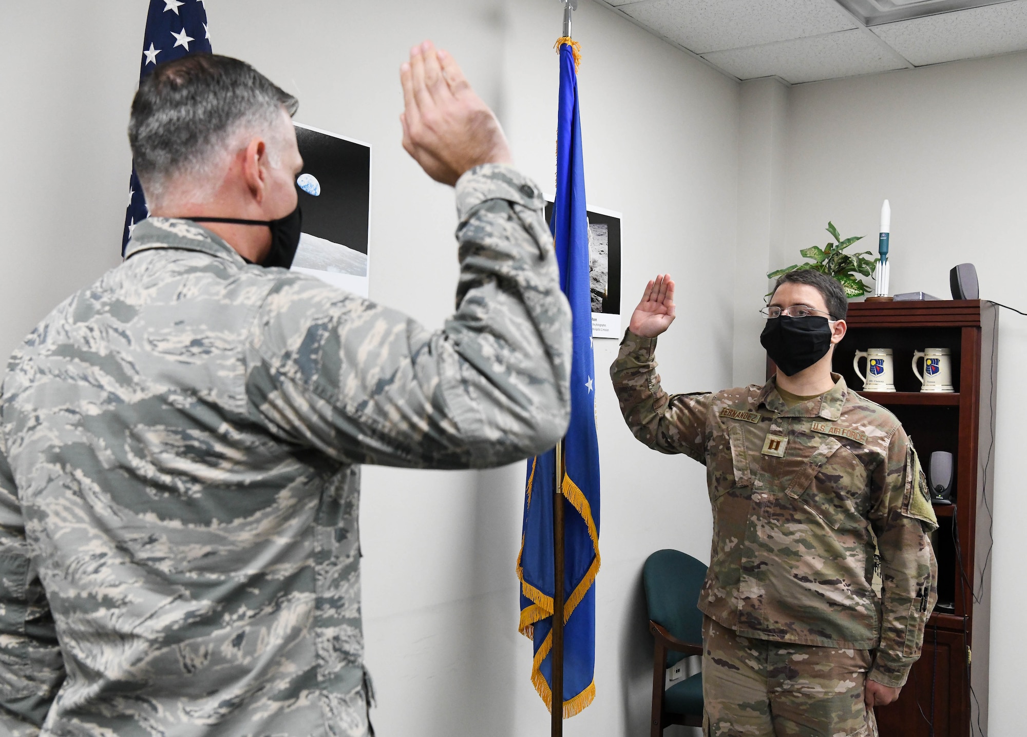 Lt. Col. Adam Quick, left, chief of the AEDC Space and Missile Test Branch, administers the oath of office to newly-promoted Capt. Chris Fernandez during a promotion ceremony, Nov. 18, 2020, at Arnold Air Force Base, Tenn. (U.S. Air Force photo by Jill Pickett)