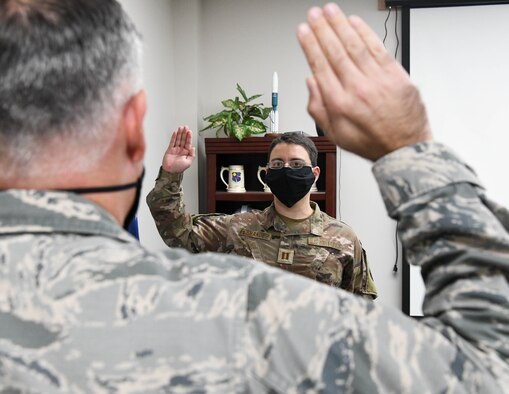 Lt. Col. Adam Quick, left, chief of the AEDC Space and Missile Test Branch, administers the oath of office to newly-promoted Capt. Chris Fernandez during a promotion ceremony, Nov. 18, 2020, at Arnold Air Force Base, Tenn. (U.S. Air Force photo by Jill Pickett)