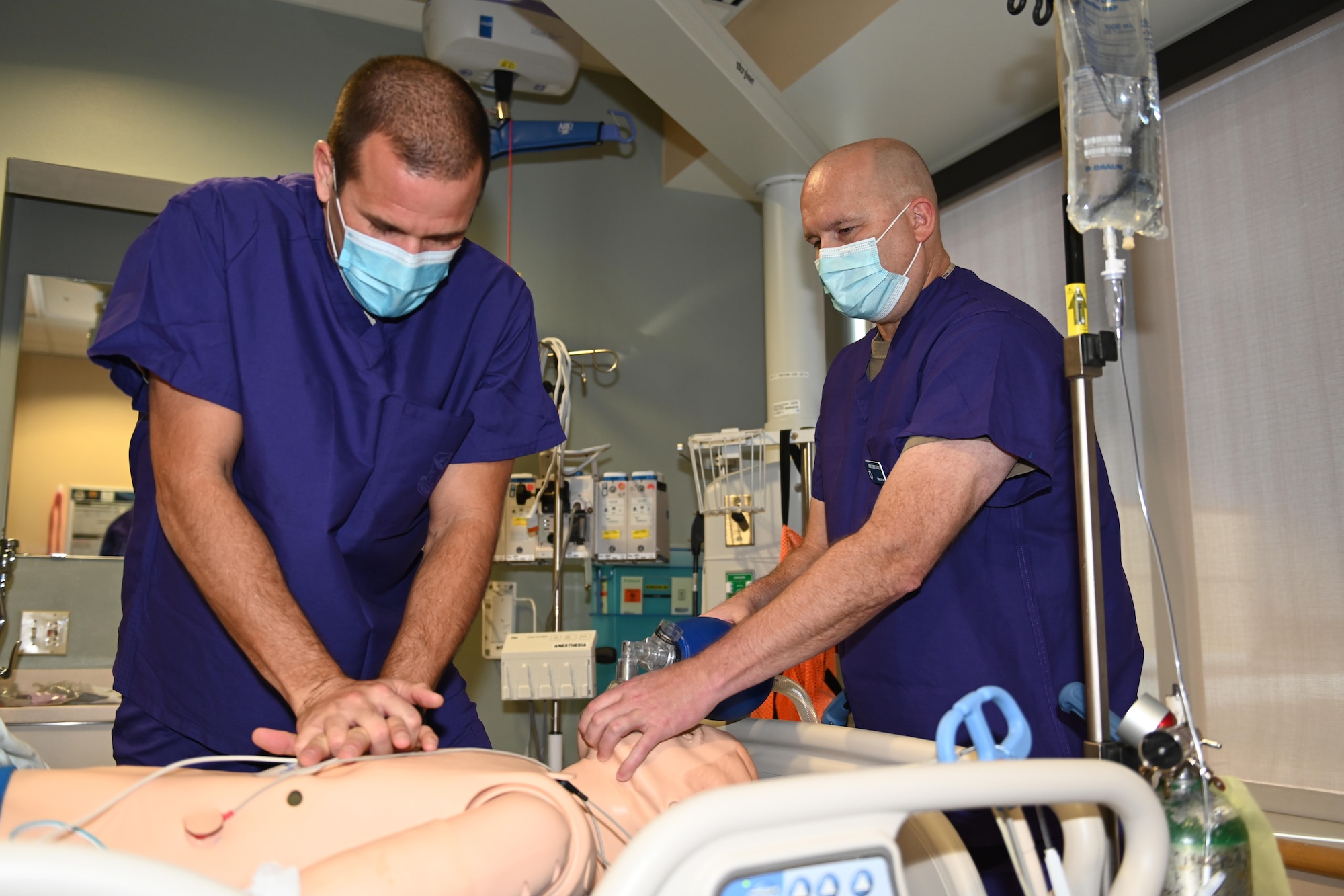 U.S. Air Force Col. Zachery Jiron, left, 60th Air Mobility Wing vice commander, and Chief Master Sgt. Robert Schultz, 60th AMW command chief, perform Adult Code Blue on a Laerdal Sim Man 3G Mannequin during Leadership Rounds Dec. 4, 2020, at Travis Air Force Base, California. Adult Code Blue is a procedure medical professionals use to help patients who are entering cardiac arrest. The Leadership Rounds program provides 60th AMW leadership an opportunity to interact with Airmen and receive a detailed view of each mission performed at Travis AFB. (U.S. Air Force photo by Senior Airman Cameron Otte)