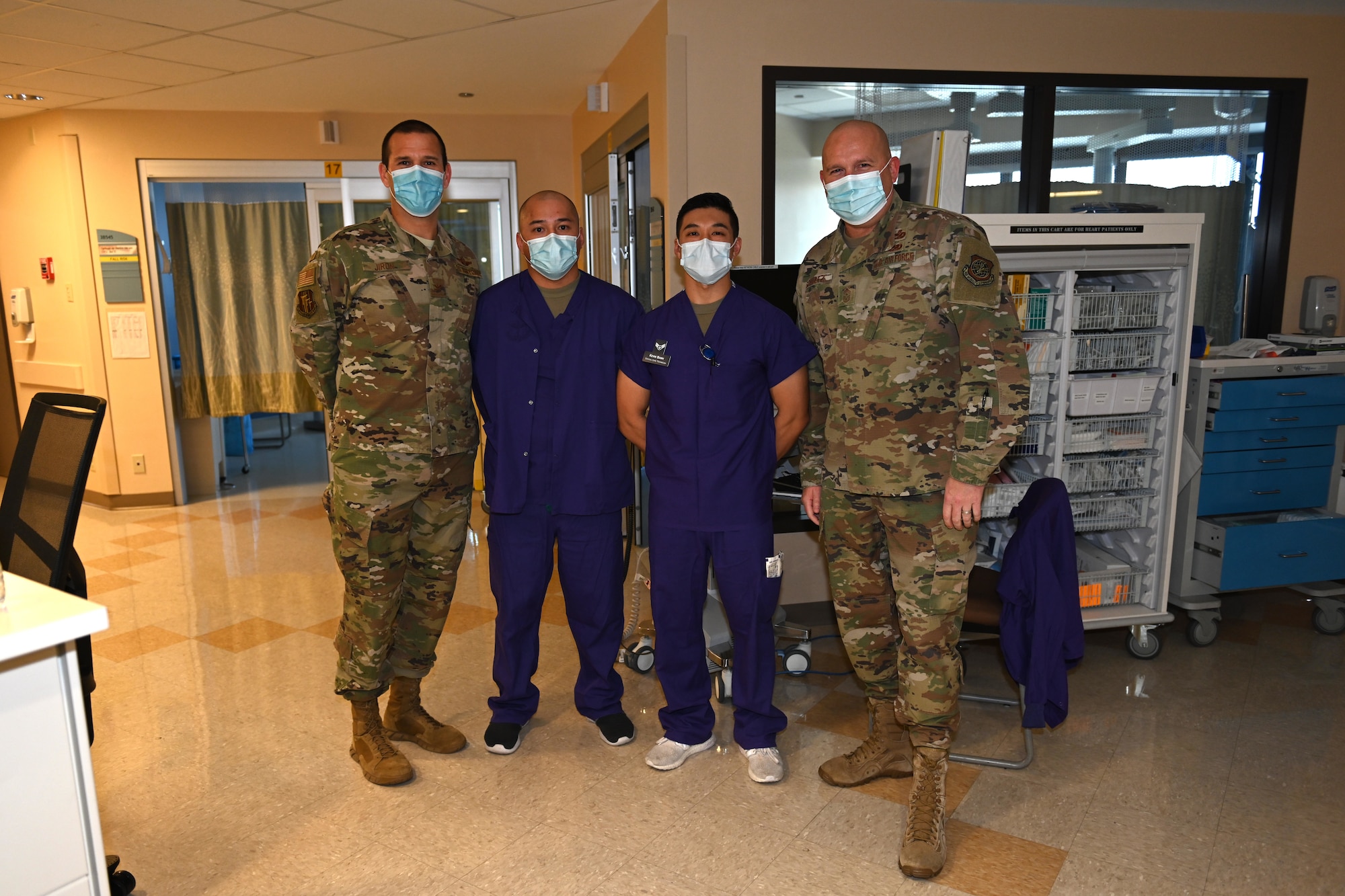 U.S. Air Force Col. Zachery Jiron, left, 60th Air Mobility Wing vice commander, and Chief Master Sgt. Robert Schultz, right, 60th AMW command chief, recognize Airman 1st Class Kevin Banh, middle right, 60th Inpatient Therapeutic Squadron critical care technician, and 1st Lt. Roman Salas, 60th Inpatient Therapeutic Squadron critical care nurse, as star performers during Leadership Rounds Dec. 4, 2020, at Travis Air Force Base, California. The Leadership Rounds program provides 60th AMW leadership an opportunity to interact with Airmen and receive a detailed view of each mission performed at Travis AFB. (U.S. Air Force photo by Senior Airman Cameron Otte)