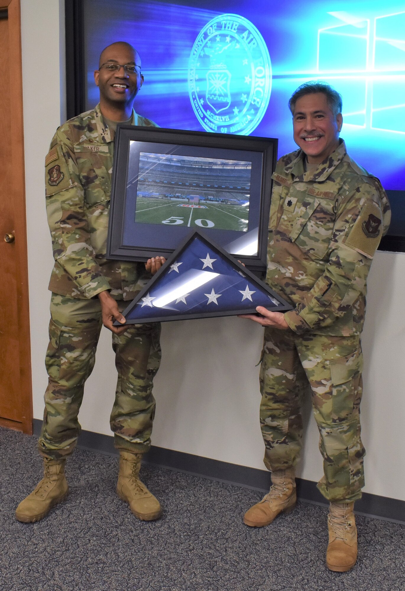 Col. Ricardo Baker, 655th Intelligence, Surveillance, and Reconnaissance Group commander, presents Lt. Col. Thomas Danas, 655th ISR Group deputy commander, a flag and framed photo during his retirement ceremony Dec. 5, 2020. Danas has held multiple positions within the enterprise since 2013 with both the 16 Intelligence Squadron and 655 ISRG and is retiring after more than 41 years of service; over 20 years enlisted and over 20 years as an officer.