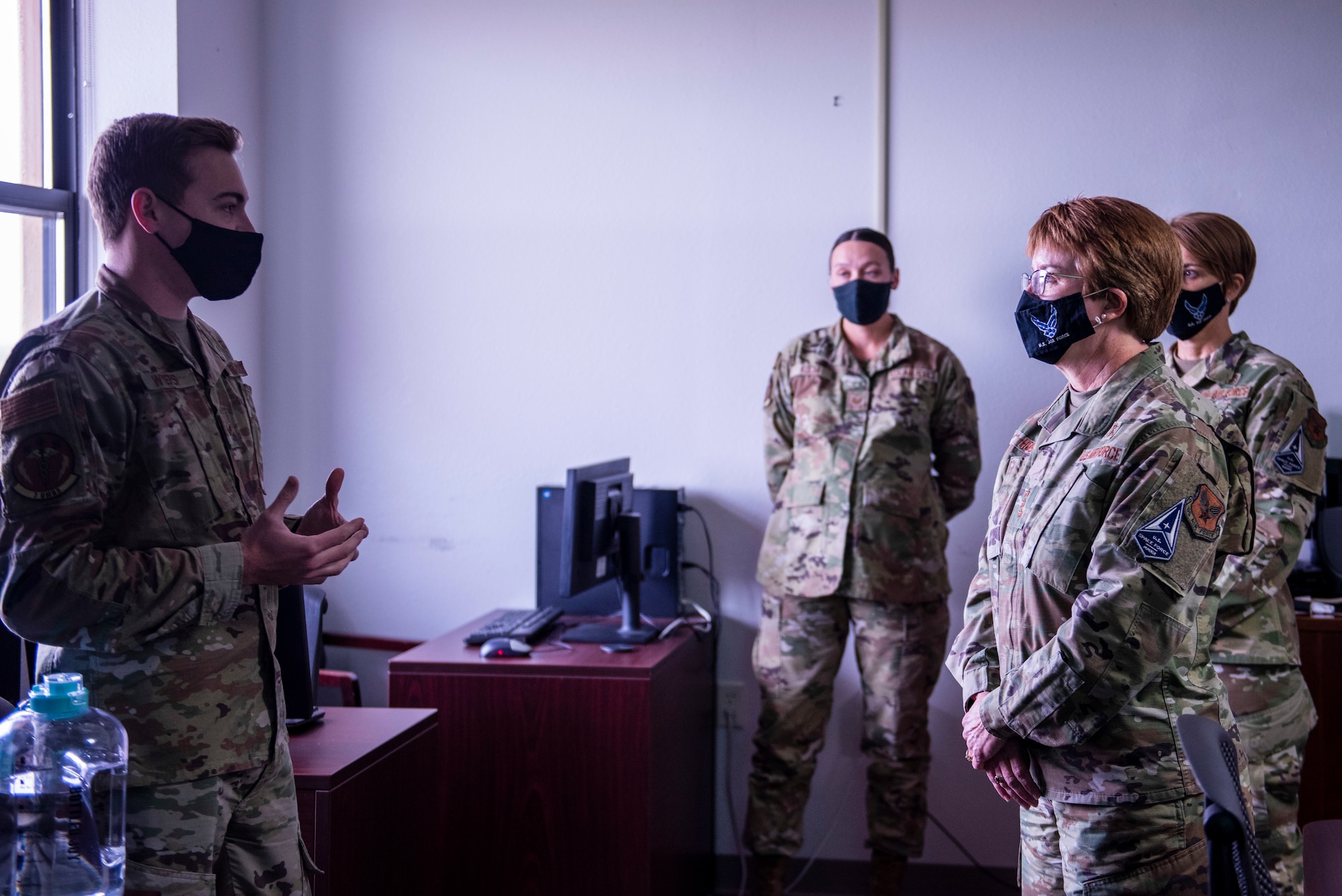 Senior Airman Colton Wyers, 7th Operational Medical Readiness Squadron bioenvironmental engineering technician, left, speaks with Lt. Gen. Dorothy Hogg, Air Force Surgeon General, right, about the squadron’s accomplishments at Dyess Air Force Base, Texas, Dec. 3, 2020.