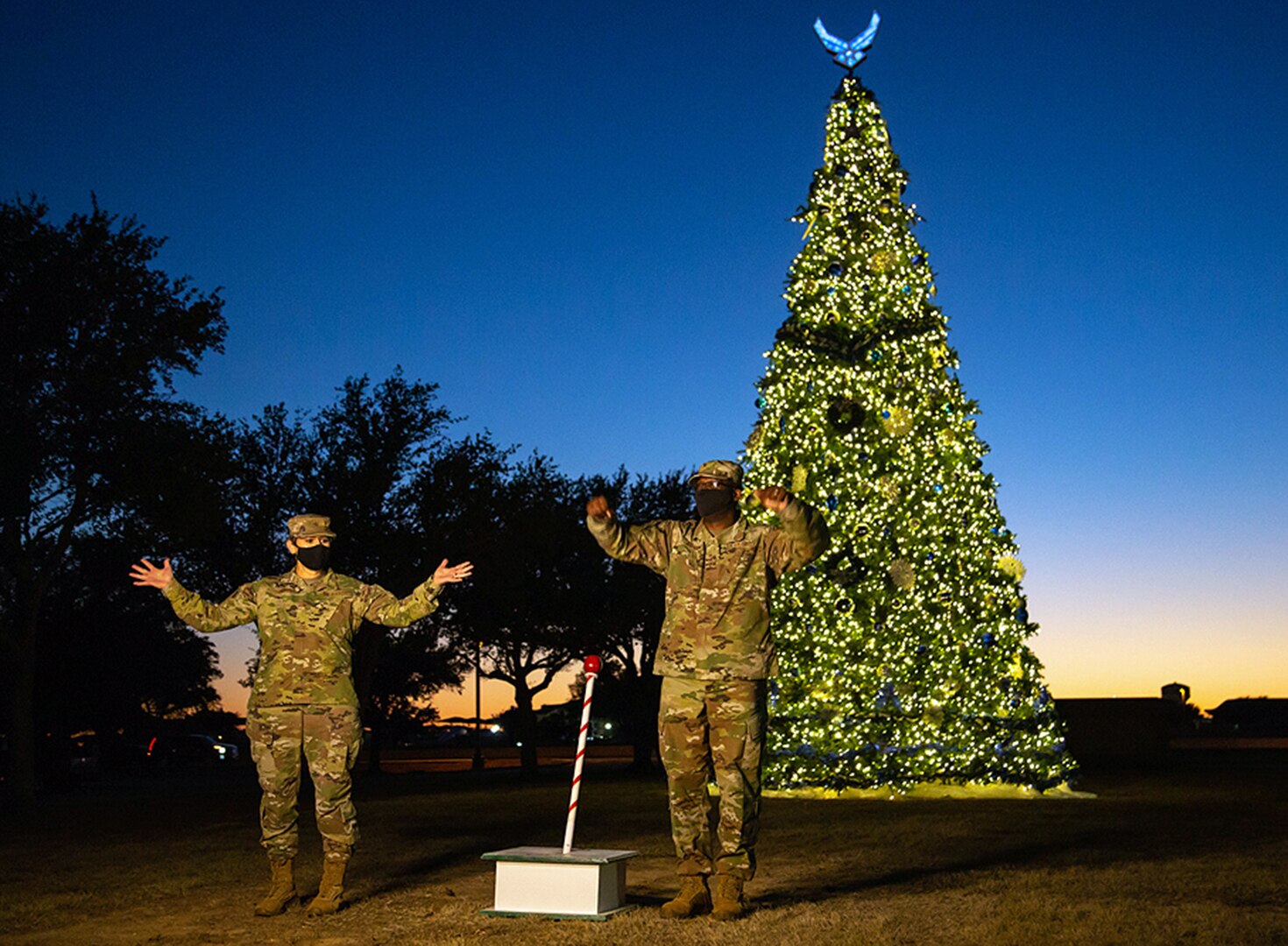Air Force Brig. Gen. Caroline M. Miller (left), 502d Air Base Wing and Joint Base San Antonio commander, and U.S. Air Force Chief Master Sgt. Wendell Snider (right) 502nd Air Base Wing and Joint Base San Antonio command chief, participate in the live streamed tree-lighting ceremony at JBSA-Lackland Dec. 2.