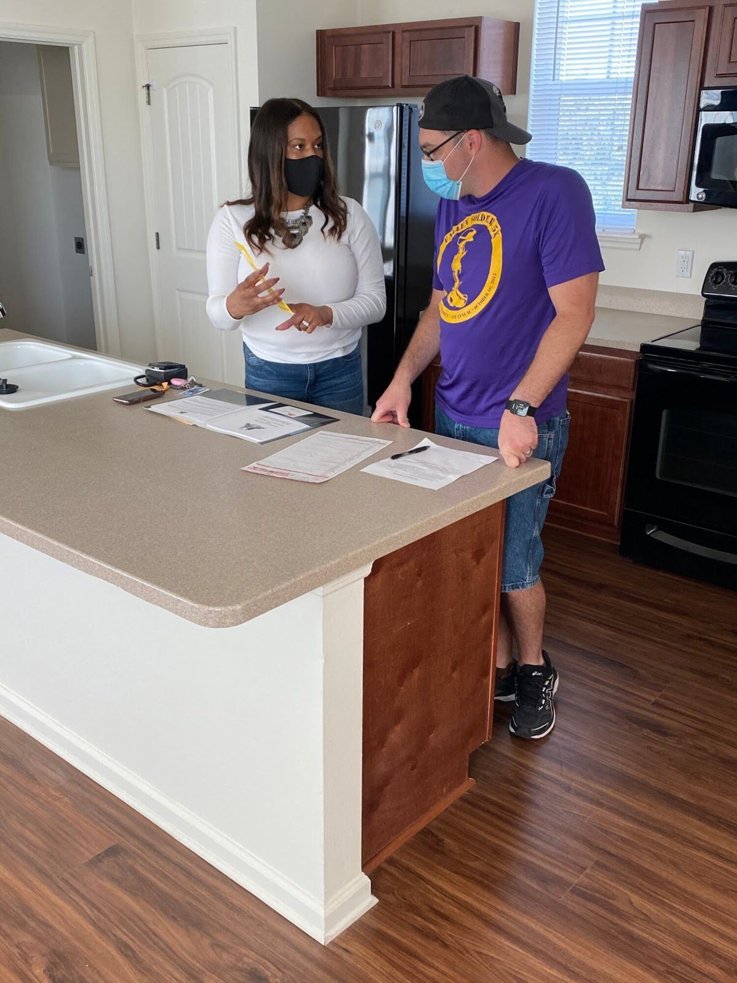 April Sinkfield, left, Harbor Bay leasing manager, explains the move-in process to a new resident of Harbor Bay at MacDill Air Force Base, Florida, Oct. 9, 2020. Despite the COVID-19 pandemic, the team at Harbor Bay have made it a priority to maintain an easy move-in experience. (Courtesy photo)