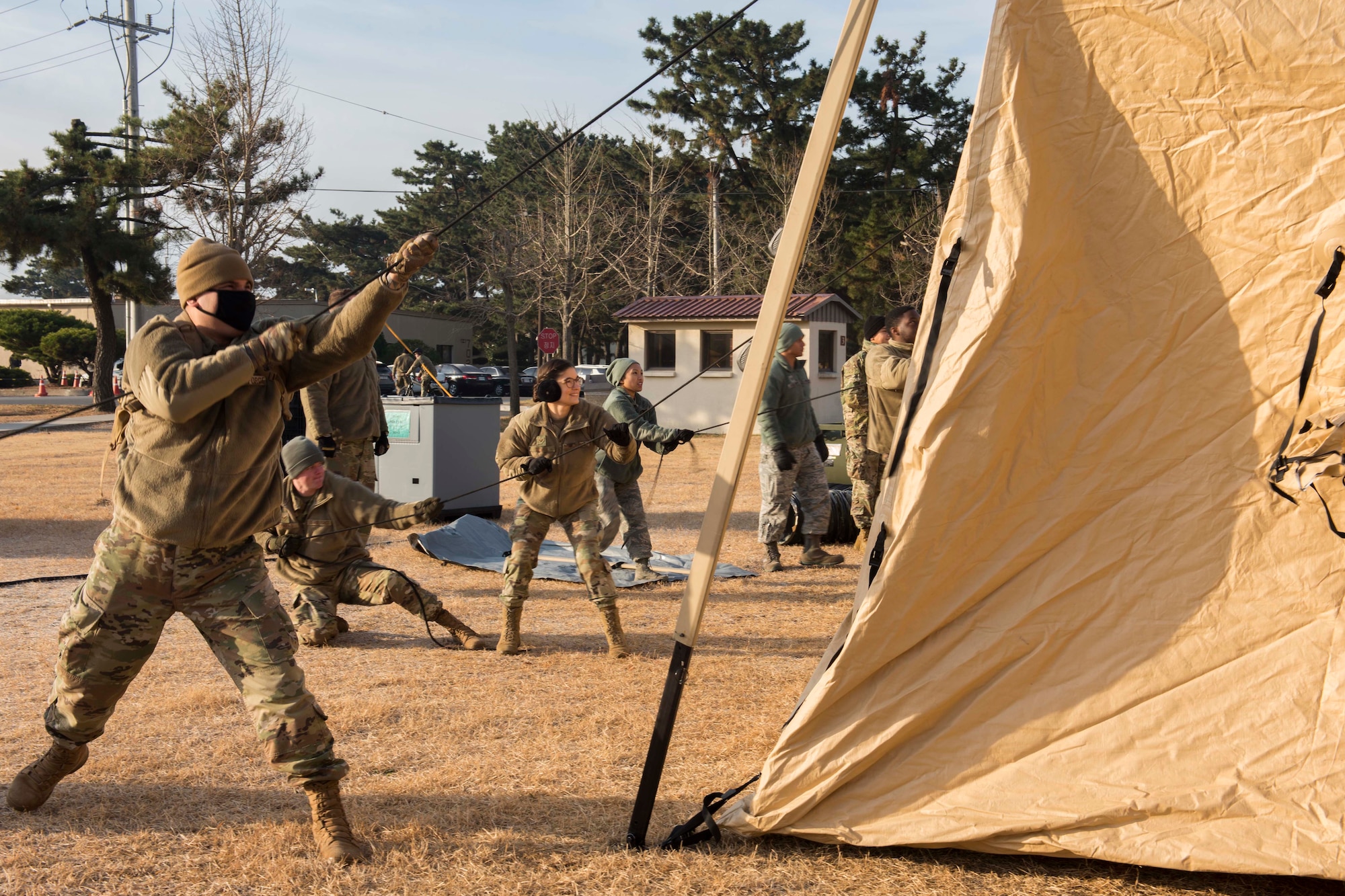 Airmen pulling a tent