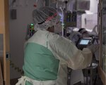 April Pace, a registered nurse, enters a patient room in a COVID-19 intensive care unit at Brooke Army Medical Center at Joint Base San Antonio-Fort Sam Houston July 17, 2020.