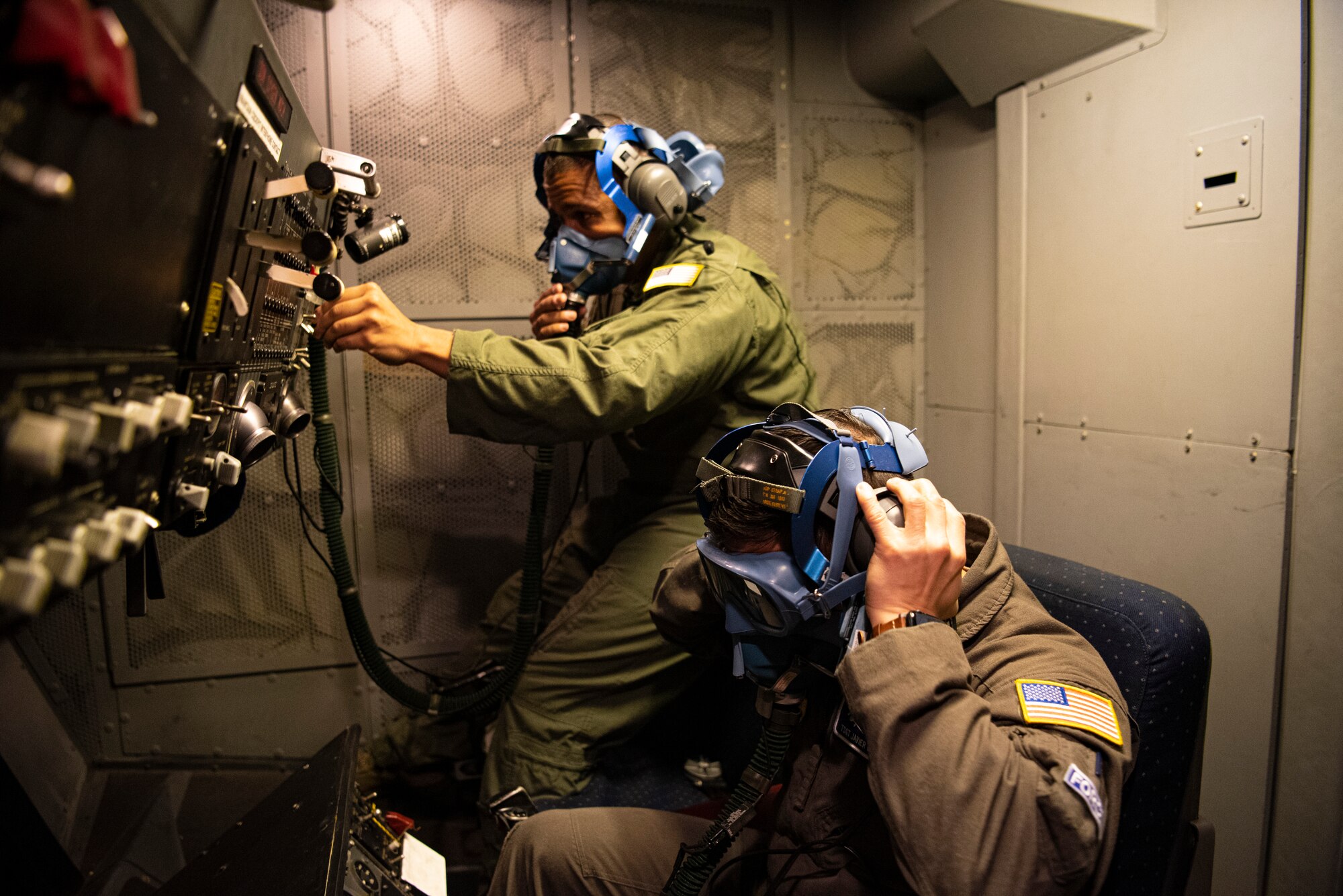 Airmen test oxygen masks.