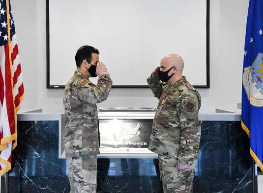 Col. Jeffrey Geraghty, left, commander, Arnold Engineering Development Complex, and Col. William Brandt exchange salutes after Geraghty presented the Legion of Merit to Brandt for his work while serving as the Individual Mobilization Augmentee to the AEDC Commander, during a ceremony Nov. 23, 2020, at Arnold Air Force Base, Tenn. IMAs are Reservists assigned to active duty units to provide specific skill sets that augment mission performance. Brandt's next assignment is Senior Reservist Adviser for the Air Force Research Laboratory Sensors Directorate at Wright-Patterson Air Force Base, Ohio. (U.S. Air Force photo by Jill Pickett)
