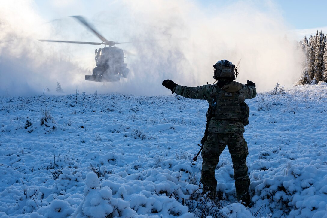 An airman directs a helicopter landing.