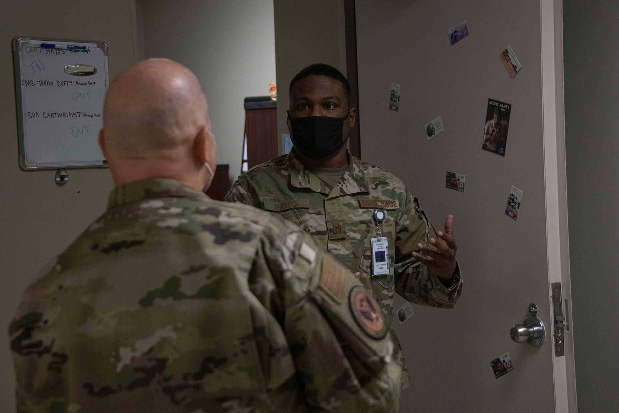 A military medical member talks to another military member