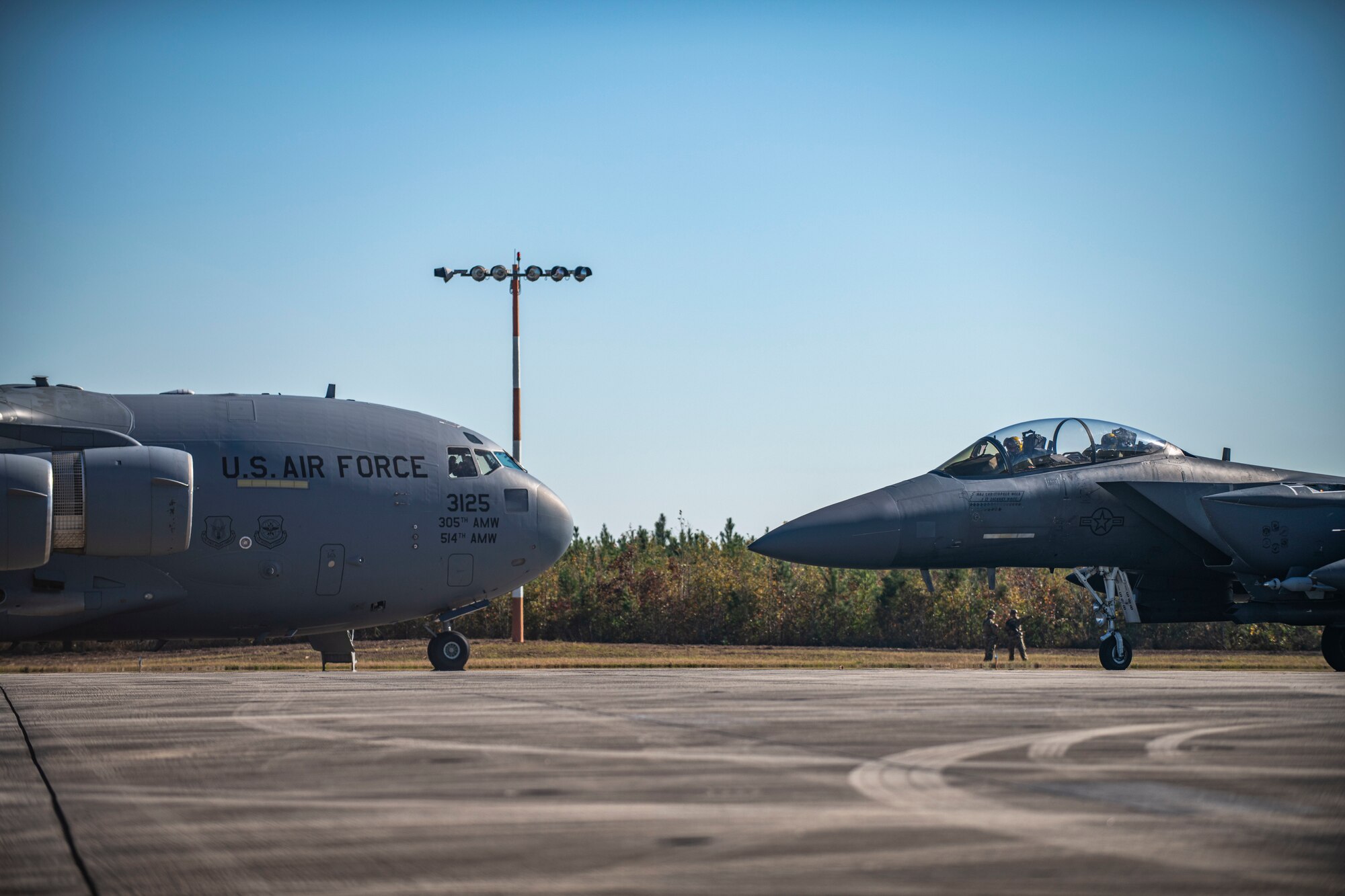 A photo of a F-15 and C-17.