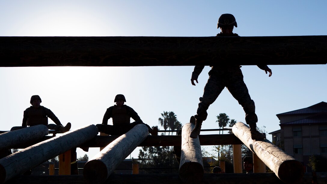 U.S. Marines with 9th Communication Battalion, I Marine Expeditionary Force Information Group navigate an obstacle course during their Marine Corps Martial Arts Program (MCMAP) Instructor course culminating event at Marine Corps Base Camp Pendleton, California, Oct. 29, 2020. MCMAP trains Marines in unarmed combat, edged weapons, weapons of opportunity, and rifle and bayonet techniques. (U.S. Marine Corps photo by Lance Cpl. Marcus Melara)