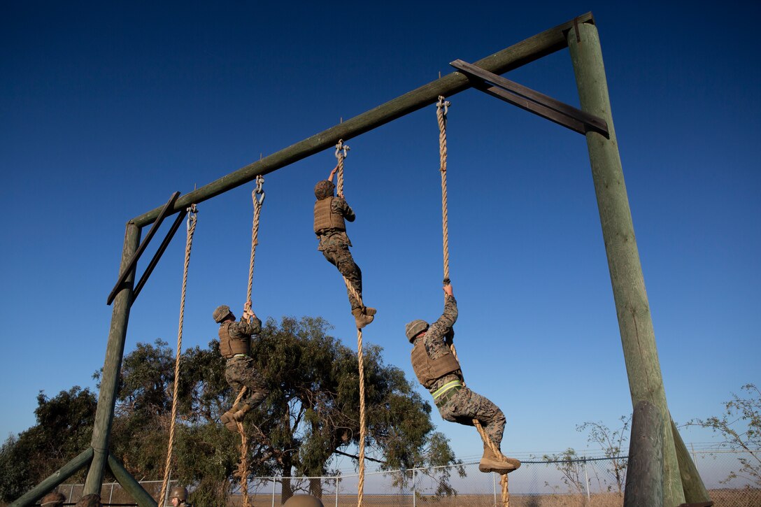 U.S. Marines with 9th Communication Battalion, I Marine Expeditionary Force Information Group climb ropes at the end of an obstacle course during their Marine Corps Martial Arts Program (MCMAP) Instructor course culminating event at Marine Corps Base Camp Pendleton, California, Oct. 29, 2020. MCMAP trains Marines in unarmed combat, edged weapons, weapons of opportunity, and rifle and bayonet techniques. (U.S. Marine Corps photo by Lance Cpl. Marcus Melara)