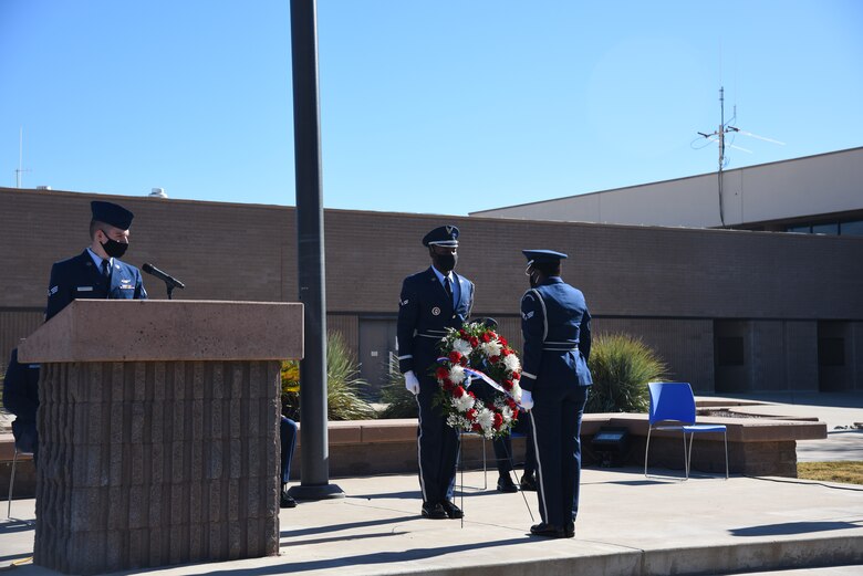 Airmen saluting a wreath