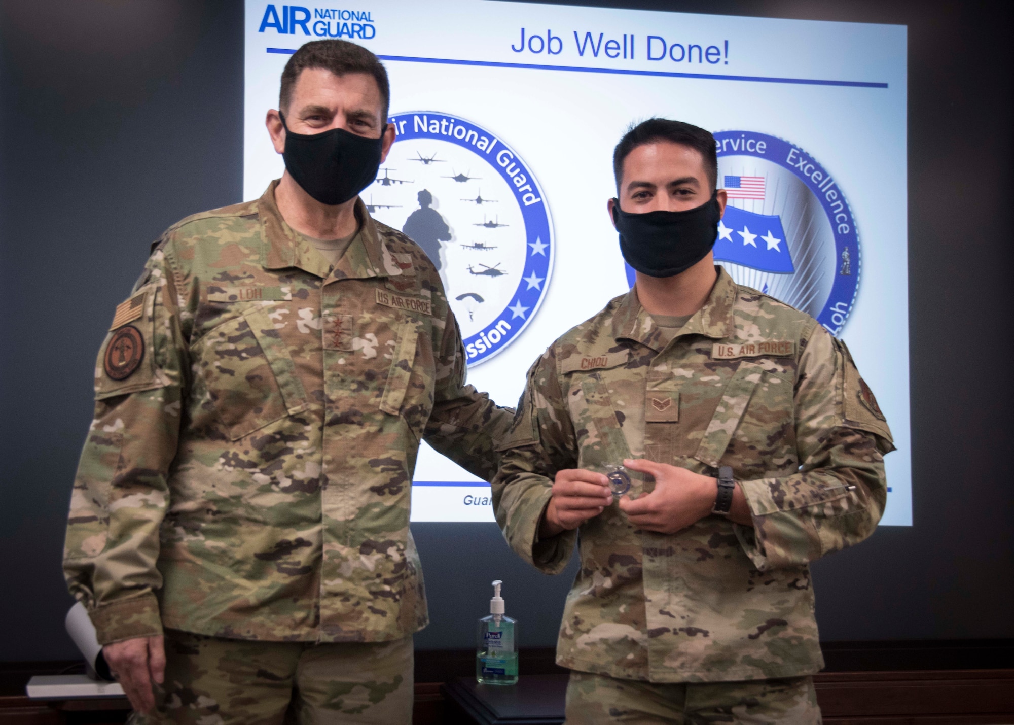 Airman receives coin from General Loh