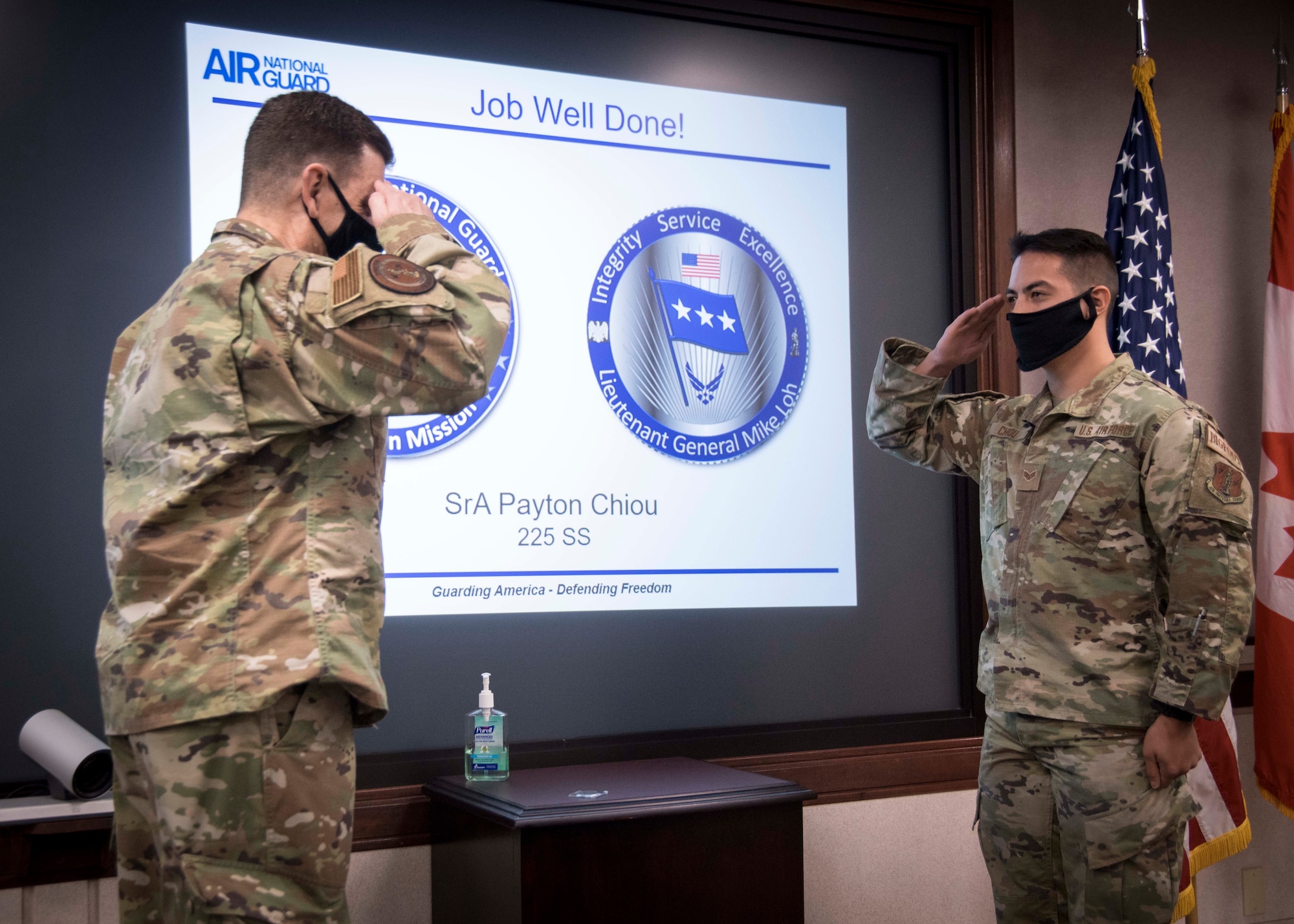 Airman receives coin from General Loh