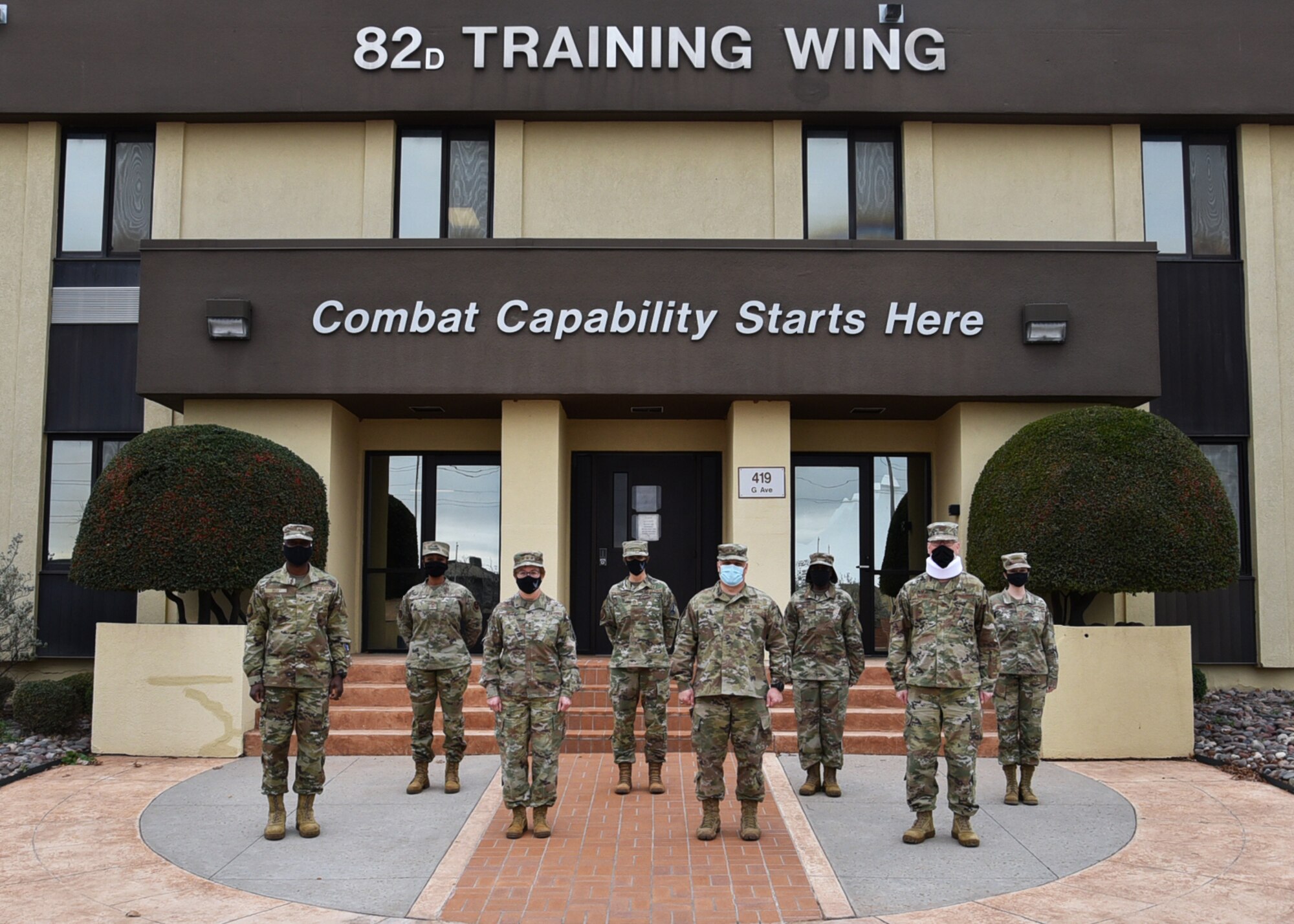 Airmen from the 82nd Training Wing leadership and the Air Force Surgeon General entourage pose for a photo at Sheppard Air Force Base, Texas, Dec. 2, 2020. Lt. Gen. Dorothy Hogg, AF Surgeon General, toured the 82nd Medical Group. She gave an All-Call to medical personnel, attended mission briefs and toured both the new and soon-to-be-replaced medical facilities. (U.S. Air Force photo by 2nd Lt. Ebony Bryant)