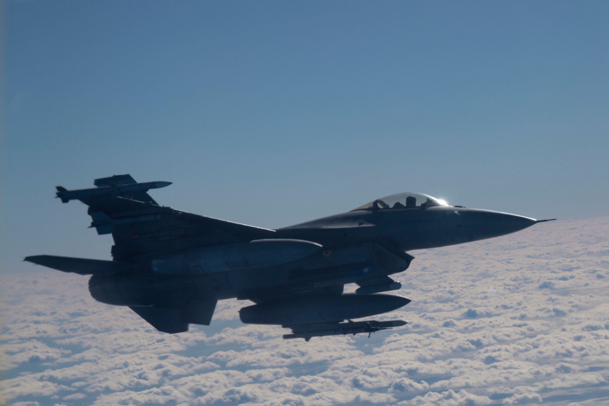 An F-16 Fighting Falcon aircraft, assigned to Shaw Air Force Base (AFB), South Carolina, flies near a KC-135 Stratotanker aircraft assigned to MacDill AFB, Florida, to provides defensive air support during a training scenario, Dec. 2, 2020.