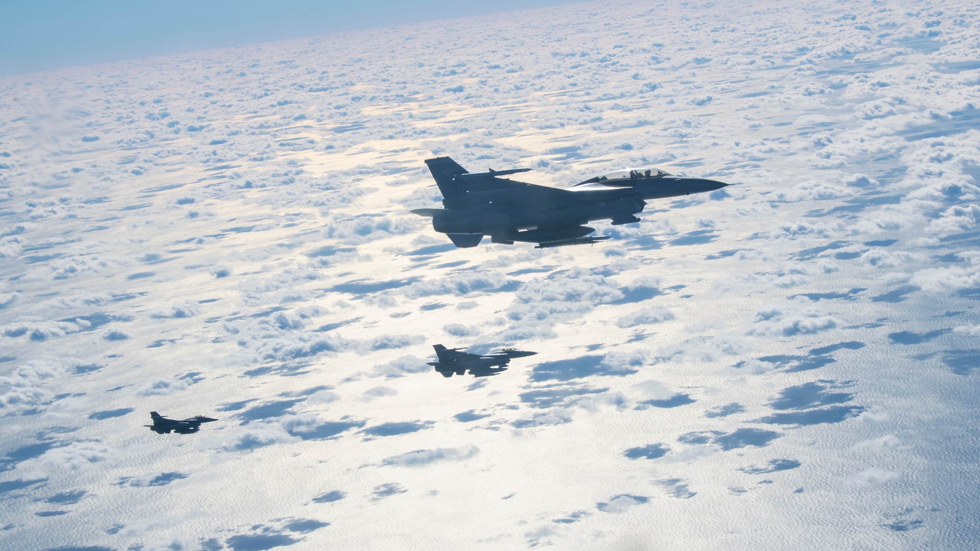 F-16 Fighting Falcon aircraft assigned to Shaw Air Force Base (AFB), South Carolina, fly in formation to provide defensive air support to KC-135 Stratotanker aircraft assigned to MacDill AFB, Florida, during a training scenario, Dec. 2, 2020.