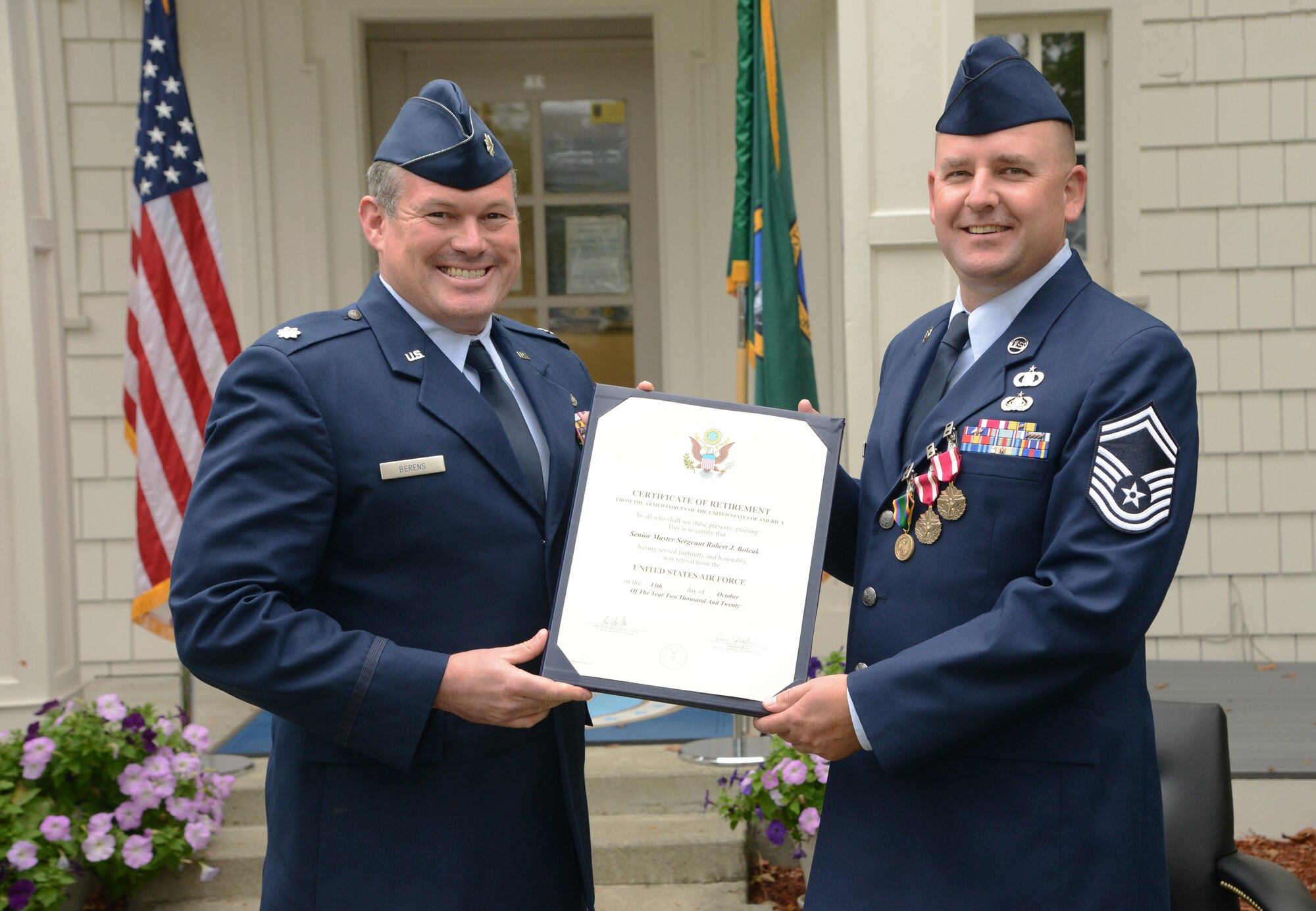 Washington Air National Guard presents Lt. Col. Mike Berens (left) presents the Certificate of Retirement from the U.S. Air Force to Senior Master Sgt. Robert Boleak, the Senior Enlisted Advisor for of Religious Affairs for the Pacific Air Forces and Air National Guard (right) during his retirement from the Air National Guard, Oct. 3, 2020, at Camp Murray, Wash. (Washington Air National Guard photo by Master Sgt. John Hughel)