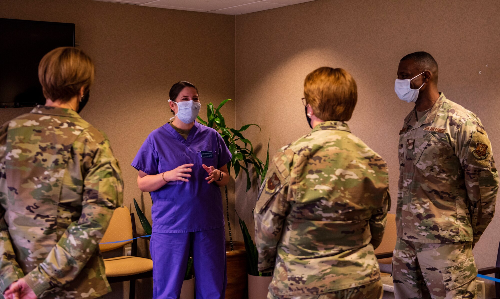 Chief Master Sgt. Dawn Kolczynski, Chief, Medical Enlisted Force and Enlisted Corps Chief, left, and Lt. Gen. Dorothy Hogg, Air Force Surgeon General, middle-right, speak with 7th Operational Medical Readiness Squadron dental clinic staff at Dyess Air Force Base, Texas, Dec. 3, 2020.