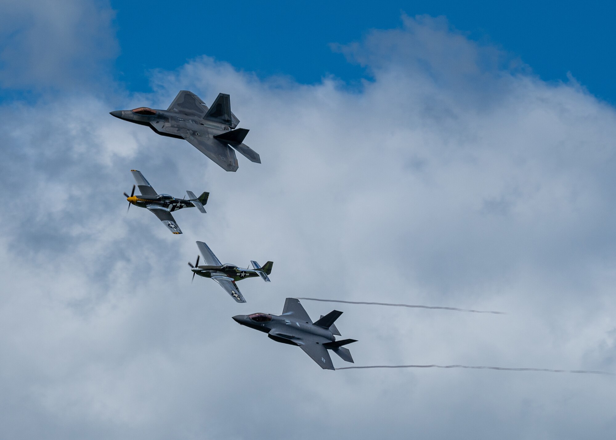 U.S. Air Force Capt. Kristin “Beo” Wolfe, F-35 Demonstration Team pilot, flies alongside Maj. Joshua “Cabo” Gunderson, F-22 Demonstration Team pilot, and two P-51 Mustangs as part of a heritage flight formation Aug. 30, 2020, Orange County Airport, NY. The heritage flight was flown as part of the 2020 New York Air Show, which was held in a drive-in format. (U.S. Air Force photo by Capt. Kip Sumner)