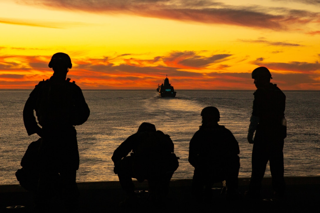 U.S. Marines and sailors post security from the Wasp-class amphibious assault ship USS Essex (LHD-2) off the coast of Southern Calif., Dec. 4.